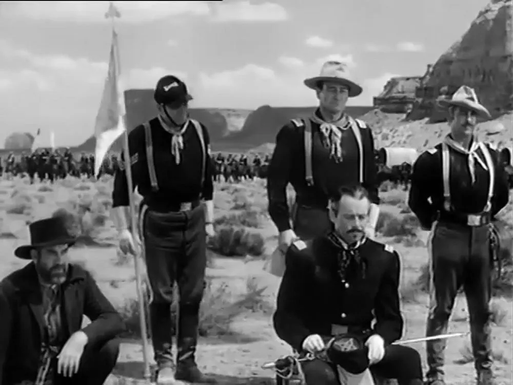 Silas Meacham (Grant Withers, far left) is accused of betraying the Apache and is called a yellow-bellied polecat by Chief Cochise.