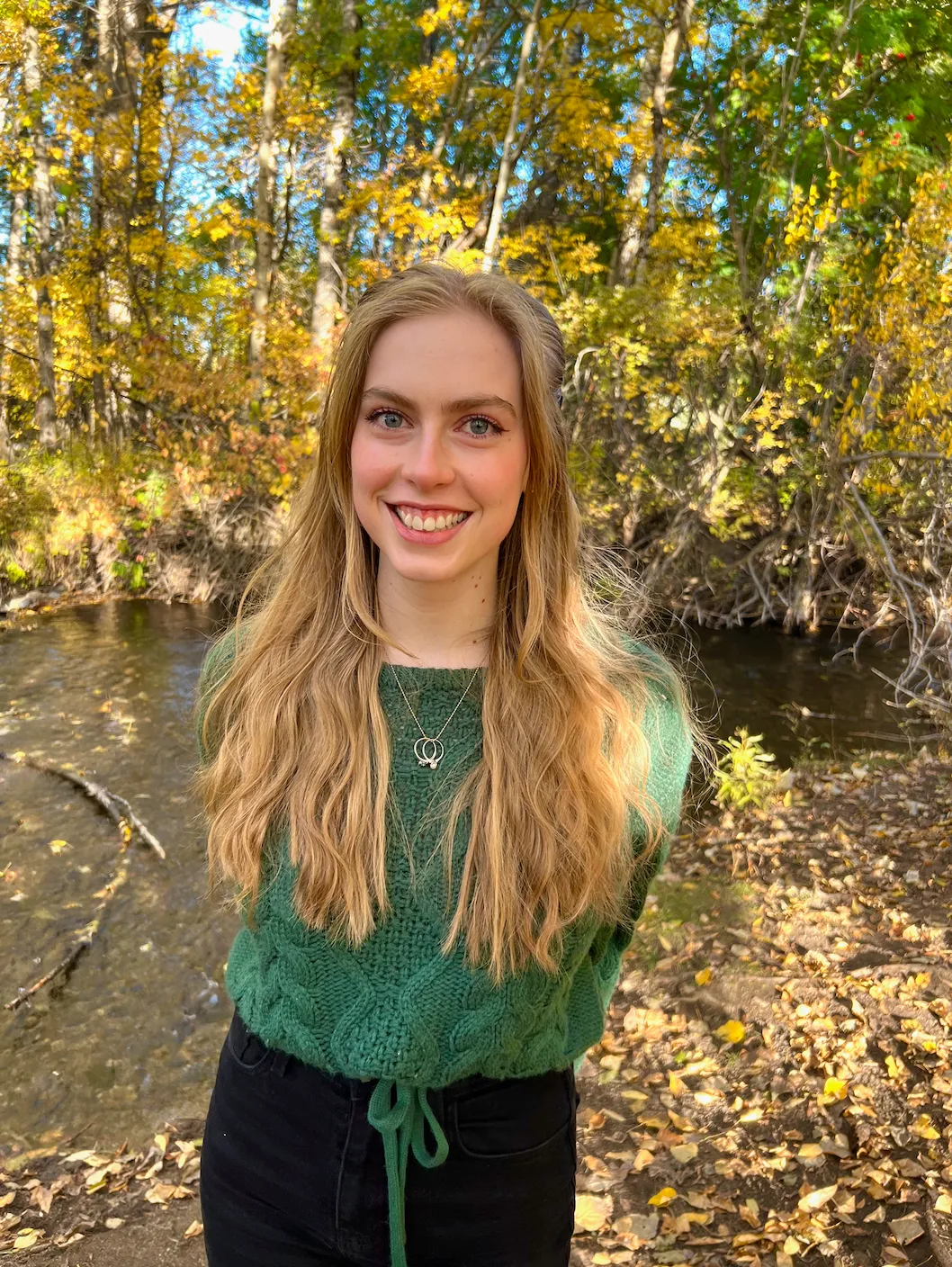 The author posing in front of a stream