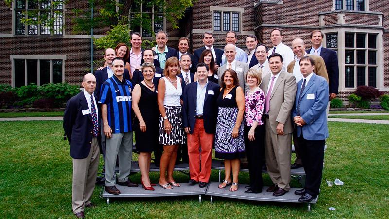 A skilled Tracey Wade horse trainer working with a beautiful bay horse on groundwork, the morning sun casting long shadows across a quiet, immaculate home arena.