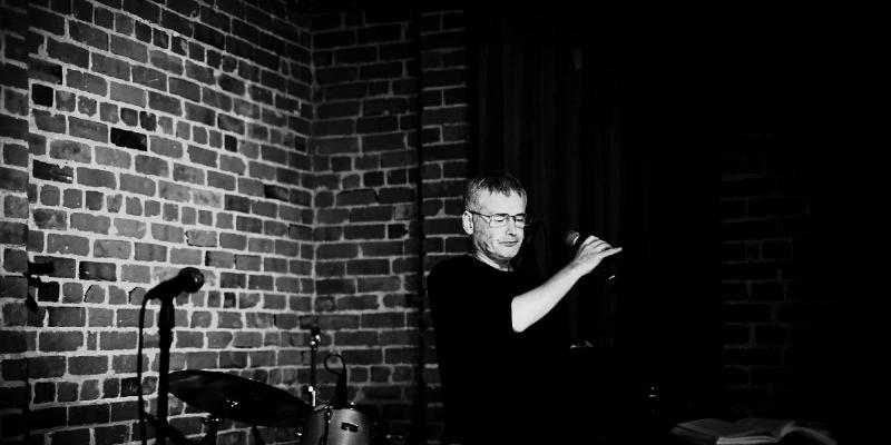 The massive Trojan Horse standing silently within the city walls of Troy at night, with a few Greek soldiers just beginning to emerge from a hidden door. A moody, atmospheric digital painting emphasizing stealth and impending doom.