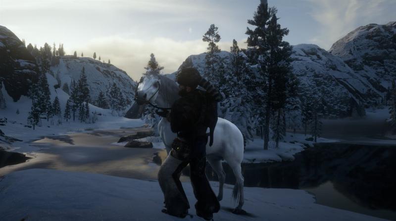 A majestic White Arabian horse standing proudly against the snowy, mountainous backdrop of Lake Isabella in Red Dead Redemption 2.