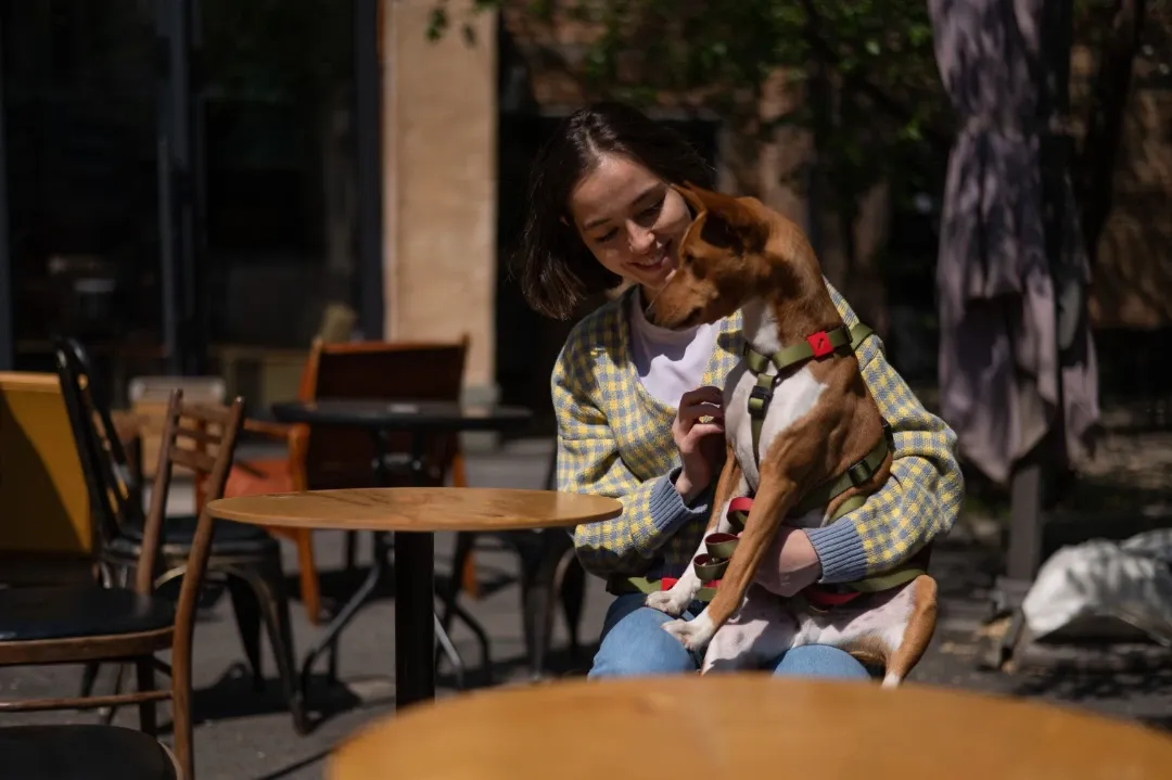 A woman in a park with her psychiatric service dog.