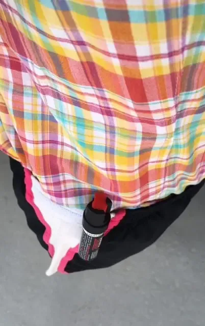 Professional dog walker wearing Clip-On Sabre Pepper Spray